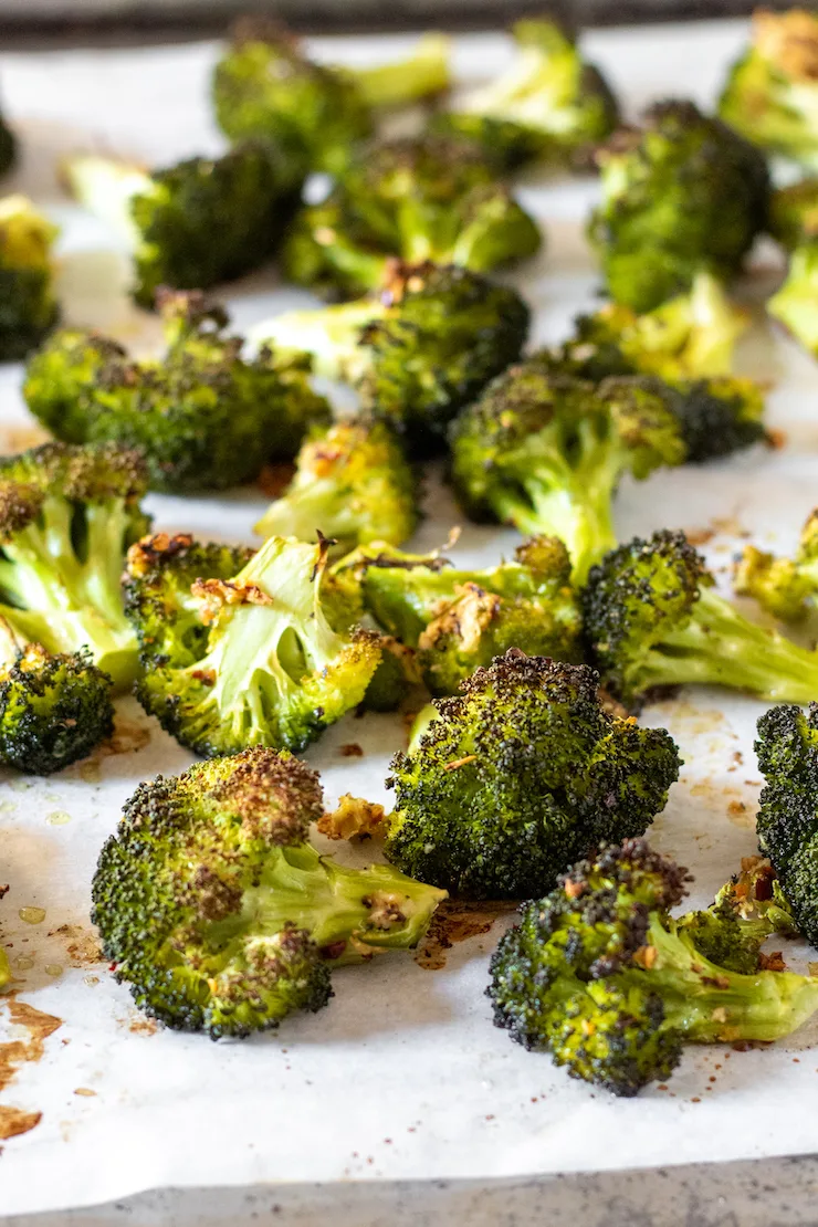 Roasted and charred broccoli on sheet pan.