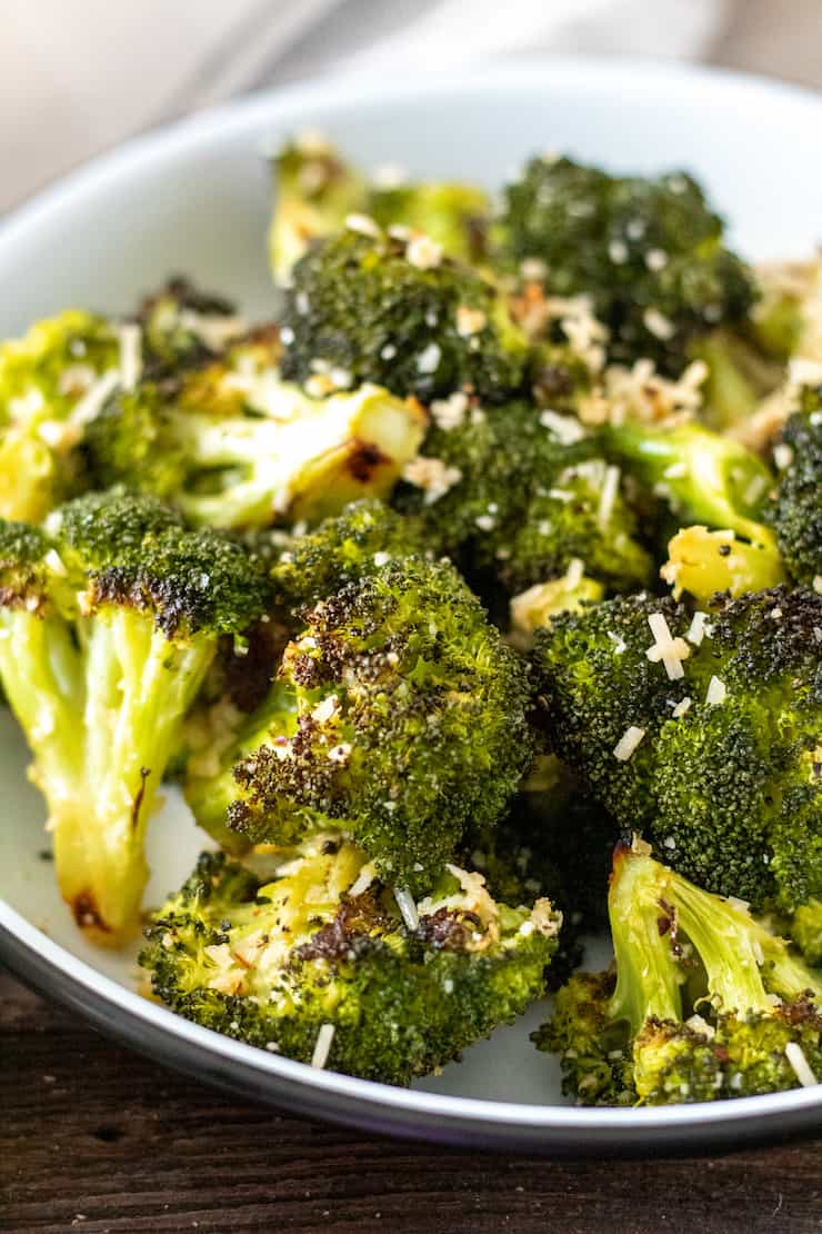 Garlic roasted broccoli in serving dish with parmesan.