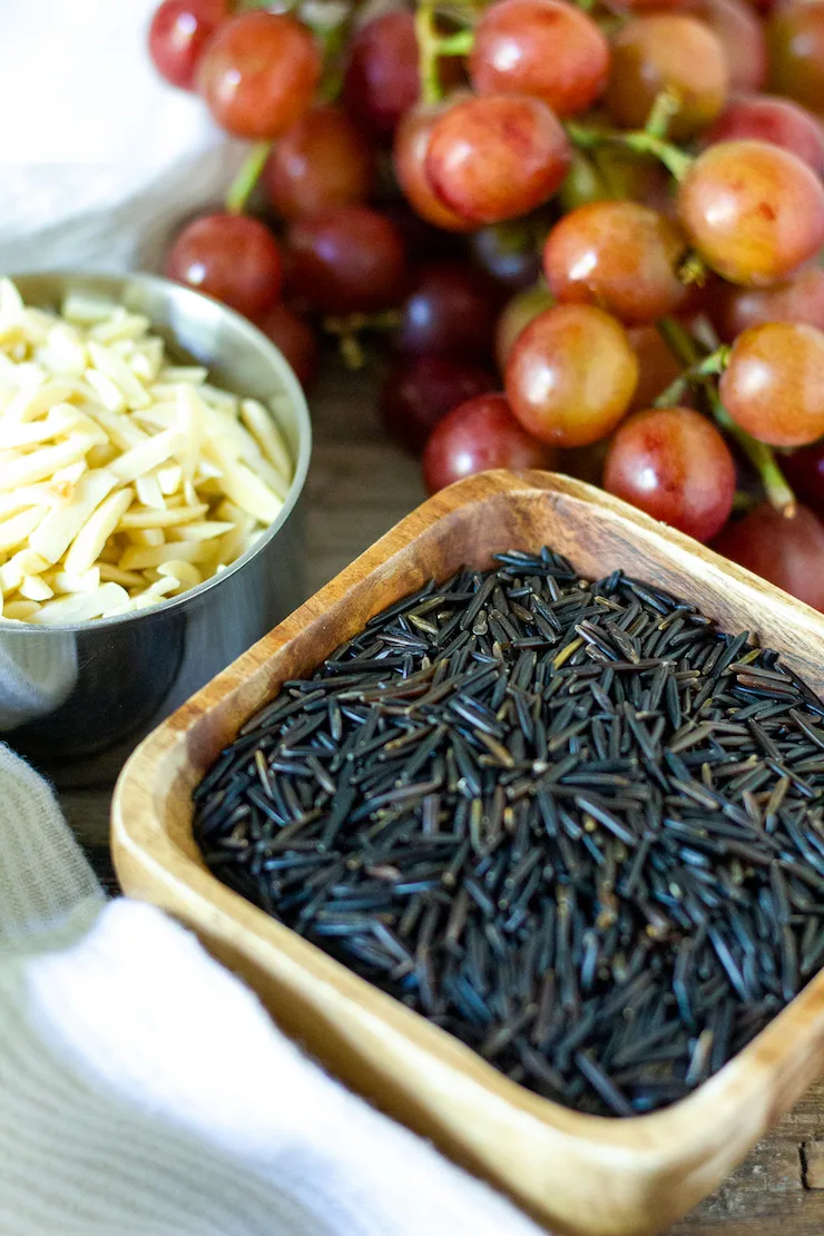 Ingredients photo of wild rice, grapes and almonds.