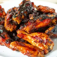 Maple bourbon grilled chicken wings on a serving plate.