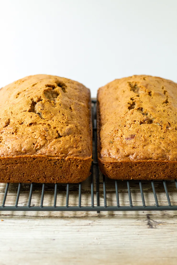 Two loaves cooling on wire rack.