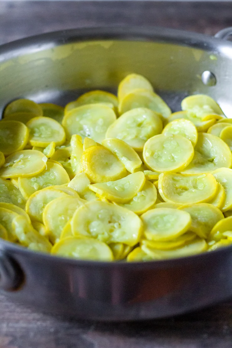 Cooking yellow squash in pan.
