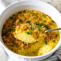 Overhead view of baked squash casserole showing a spoonful.