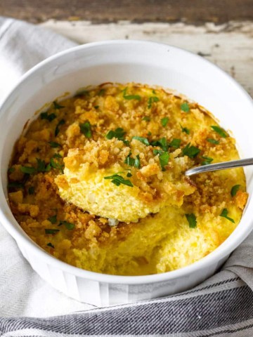 Overhead view of baked squash casserole showing a spoonful.
