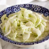 Creamy cucumber salad in serving bowl.