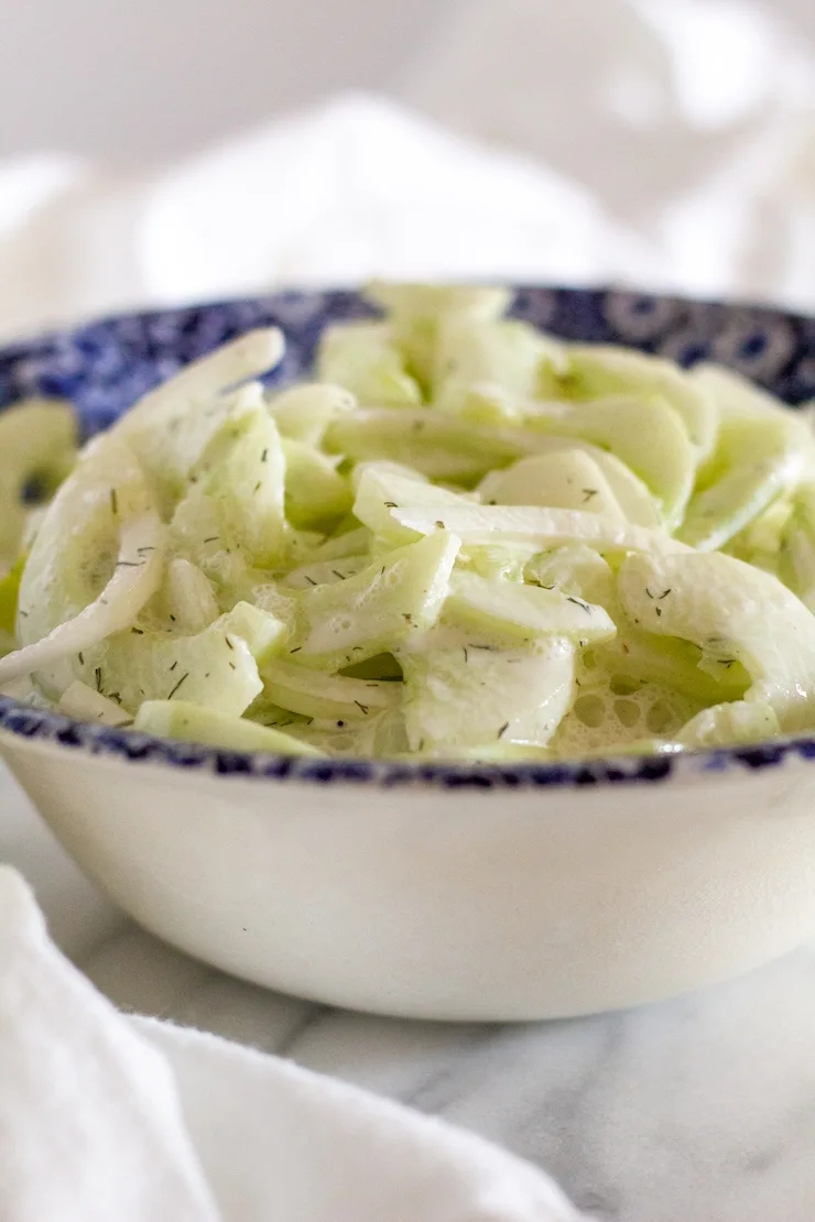 Side view of salad in blue serving bowl.