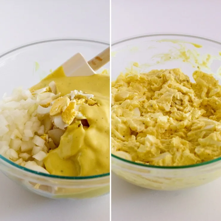 Mixing potato salad with onions and dressing.