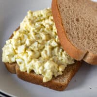 Open faced egg salad snandwich on wheat bread.