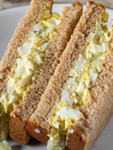 Egg salad sandwich cut in half.