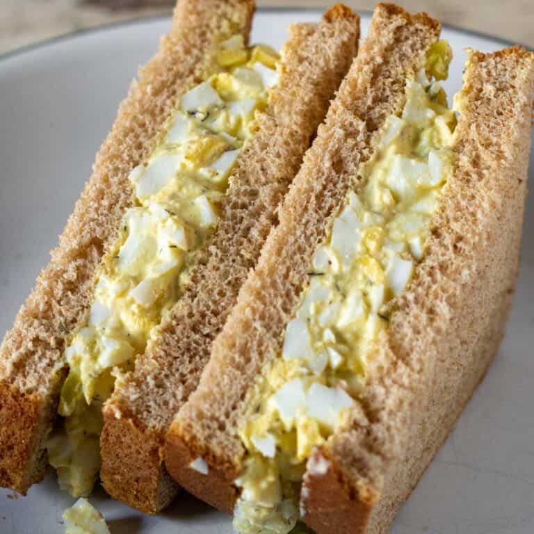 Egg salad sandwich cut in half.