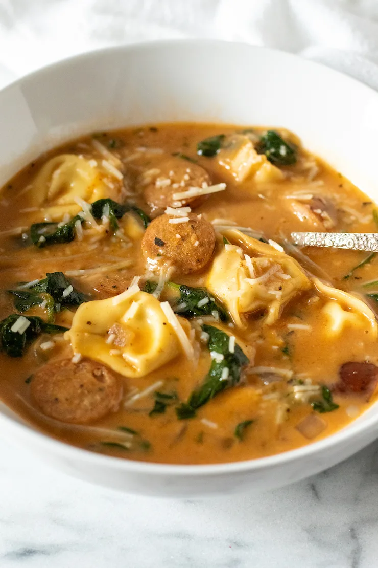 Bowl of Cajun tortellini soup with sppon.