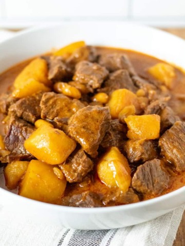 Massaman beef curry in white serving bowl.