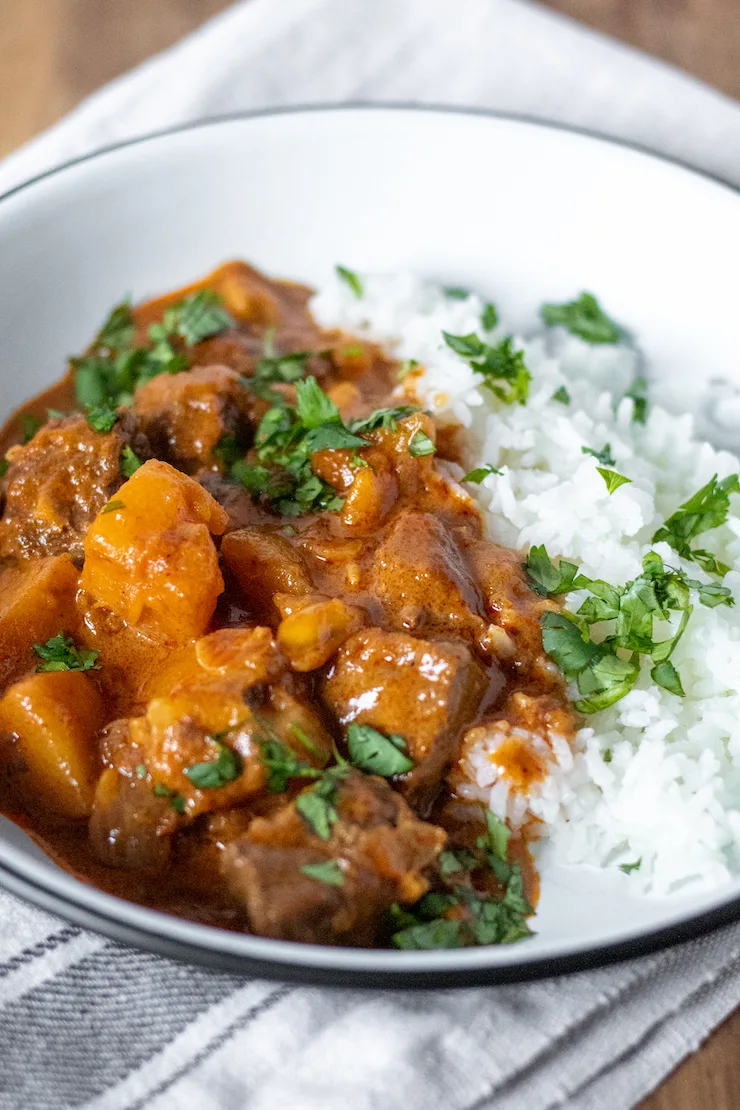 Plate of Instant Pot Massaman beef curry with white rice.
