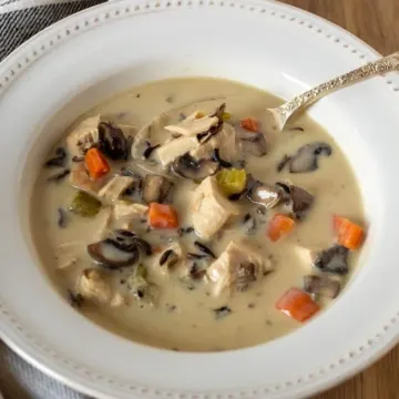 Overhead of bowl of chicken wild rice soup with spoon.