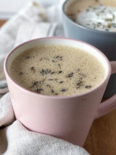 Honey lavender oat milk latte in pink cup.