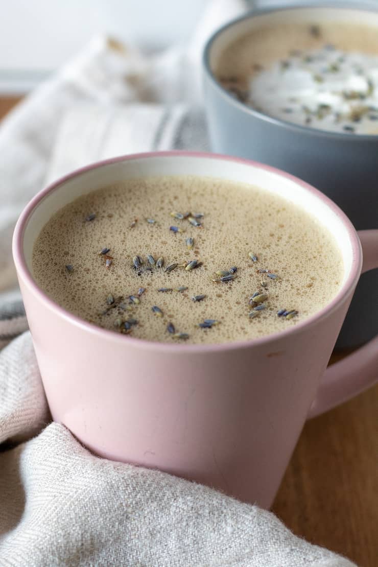 Honey lavender oat milk latte in pink cup.