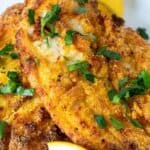 Pin for Pinterest with text overlay, photo of crispy air fried catfish on plate with lemon.