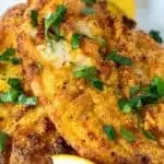 Pin for Pinterest with text overlay, photo of crispy air fried catfish on plate with lemon.