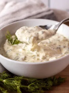 Homemade tartar sauce in white serving bowl with spoon.