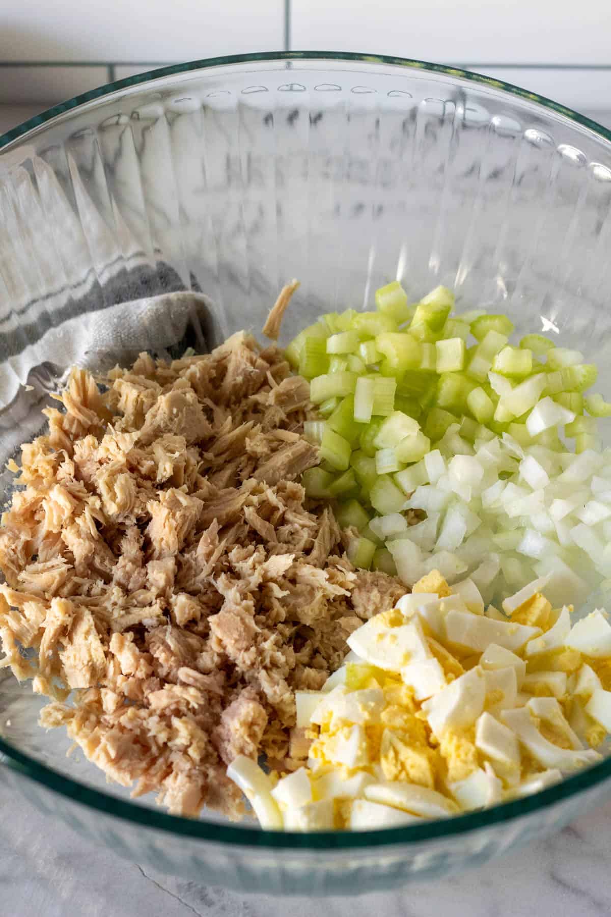 Tuna, celery, onion and hard boiled egg in mixing bowl.