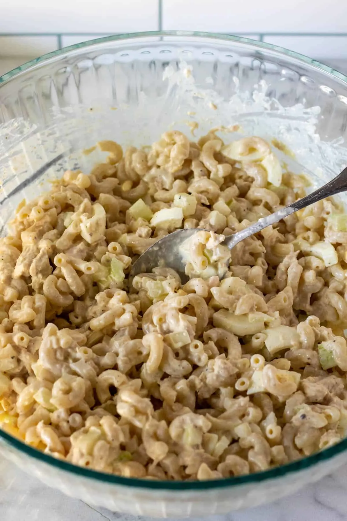 Combining all ingredients together in bowl with spoon.