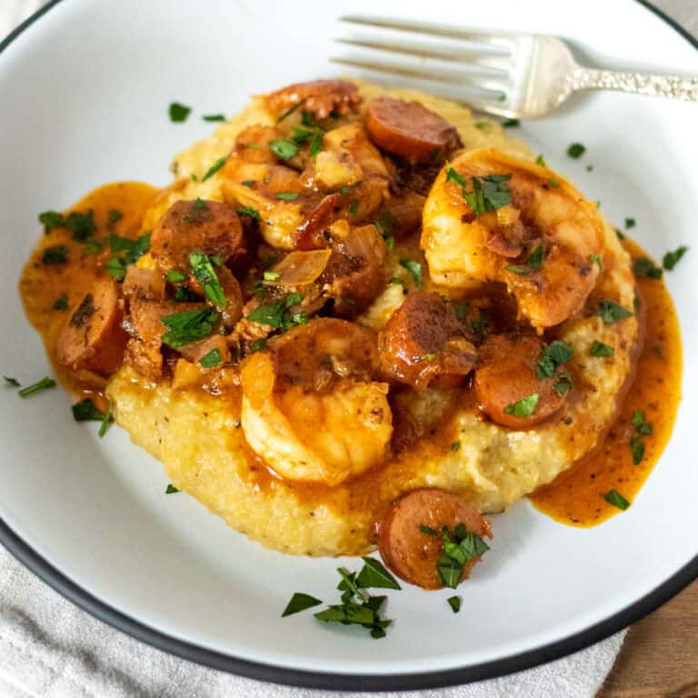 Shrimp and grits on plate with fork.