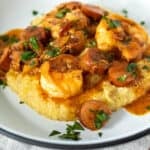 Shrimp and grits on white plate.