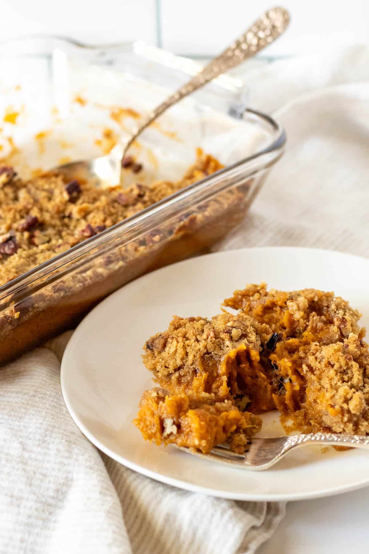 White plate with serving of sweet potato casserole.