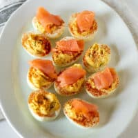 Smoked salmon deviled eggs on white platter.