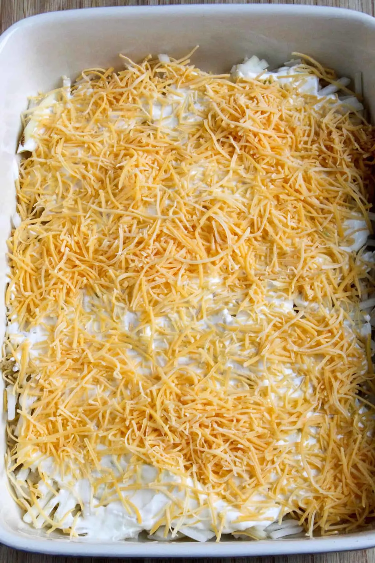 Process photo showing layering with cheese on top.